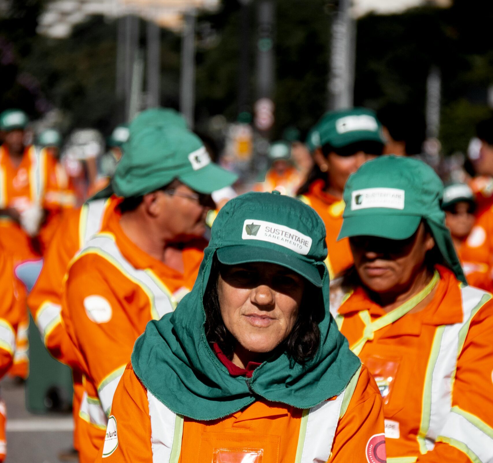 Group of uniformed street cleaners working outdoors in São Paulo, Brazil.